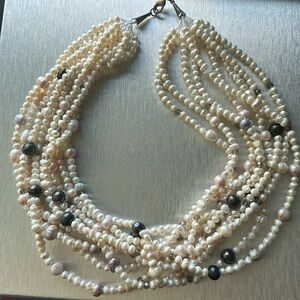 Fresh water pearl necklace 
Sterling’s silver clasp
Statement piece 
9 strand